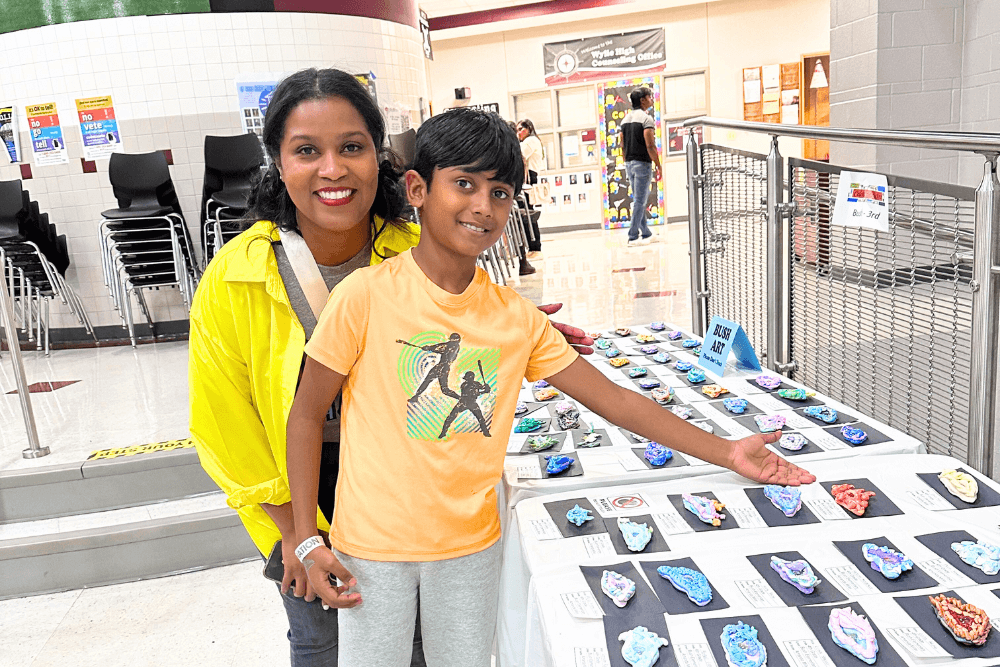 Young artist Yashwanth and his mom at the Wylie ISD Celebrating the Arts event, proud of Yashwanth's showcased artwork.