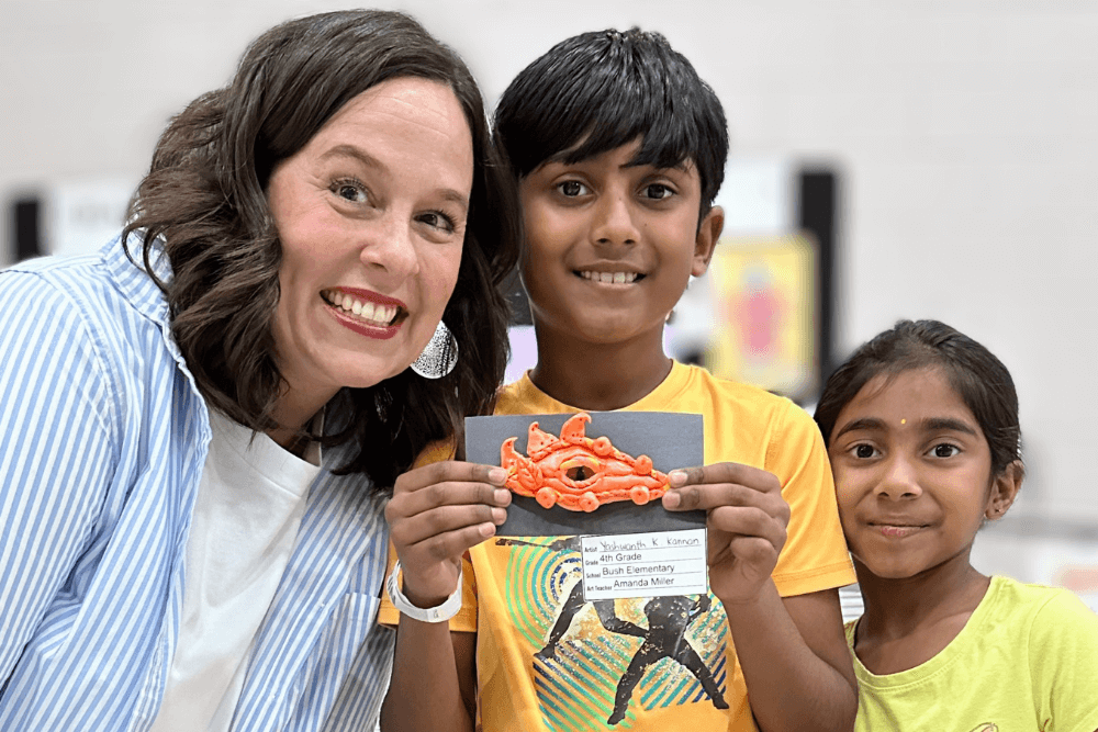 Young artist Yashwanth holding his craft selected for Wylie ISD Celebrating the Arts, with his art teacher by his side.