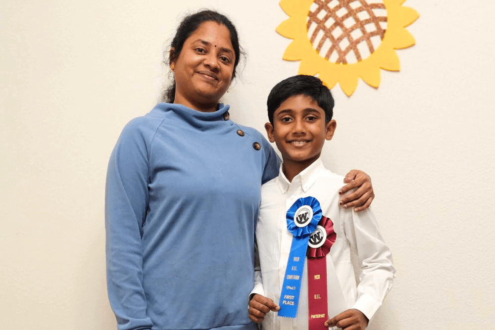 A proud moment of Yashwanth and his mom, both smiling and holding the first-place award at the UIL Math Competition event.