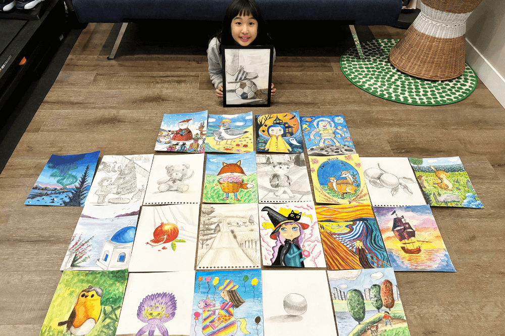 Bella proudly displays her collection of colorful artworks, showcasing her creativity and artistic growth.